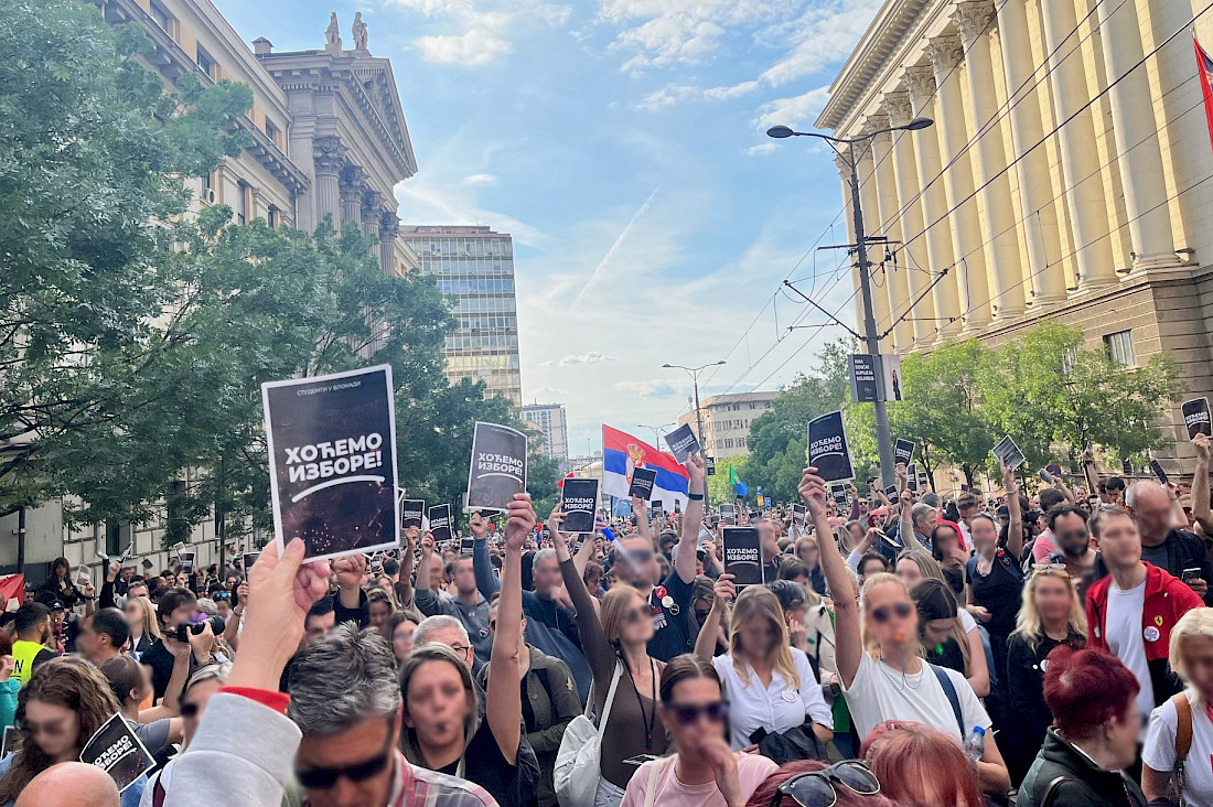 Protestors in Belgrade with signs saying “We want elections!”